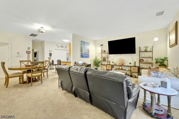 a living room with lots of furniture and a flat screen tv