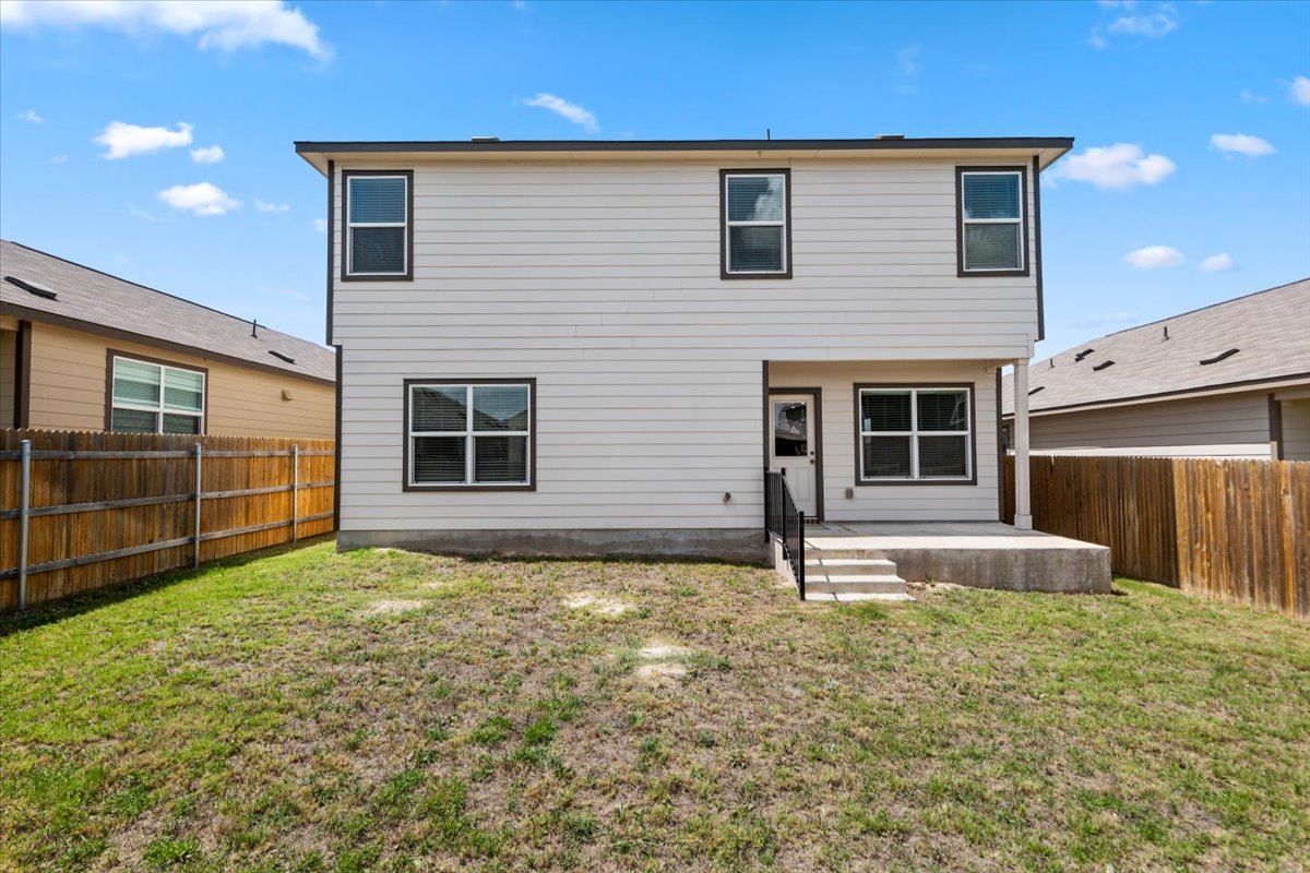 448 Perfect World Loop Jarrell, TX 76537 - Photo 6 of 40 A well-maintained fenced yard offers a private outdoor space for leisure and entertaining.