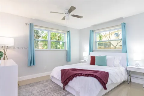 a bedroom with a large bed and a window