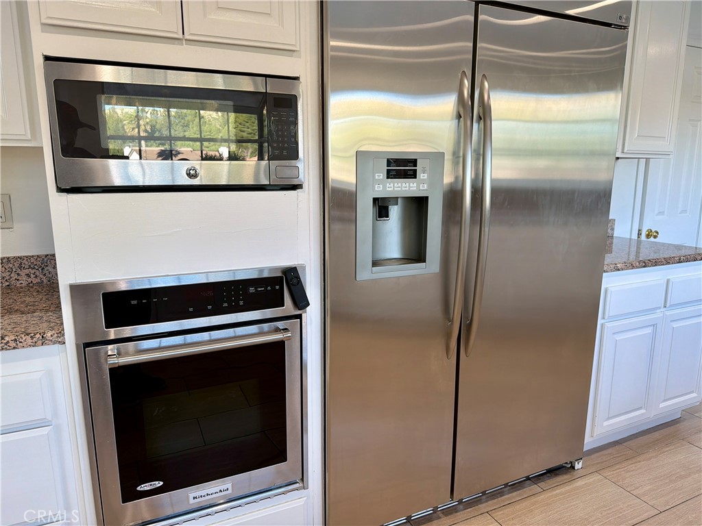 11932 Sonoma Way Porter Ranch, CA 91326 - Photo 17 of 63 a kitchen with a refrigerator and a stove