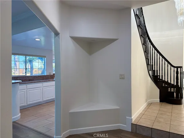 a view of a hallway with wooden floor and entryway