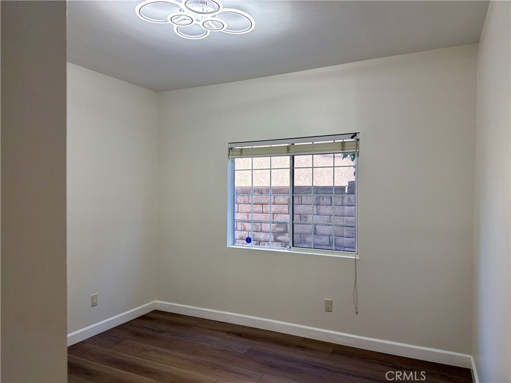 11932 Sonoma Way Porter Ranch, CA 91326 - Photo 21 of 63 a view of an empty room with wooden floor and a window