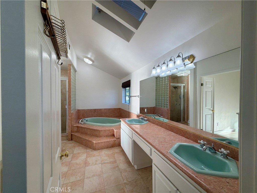 11932 Sonoma Way Porter Ranch, CA 91326 - Photo 39 of 63 a spacious bathroom with a granite countertop sink and a mirror