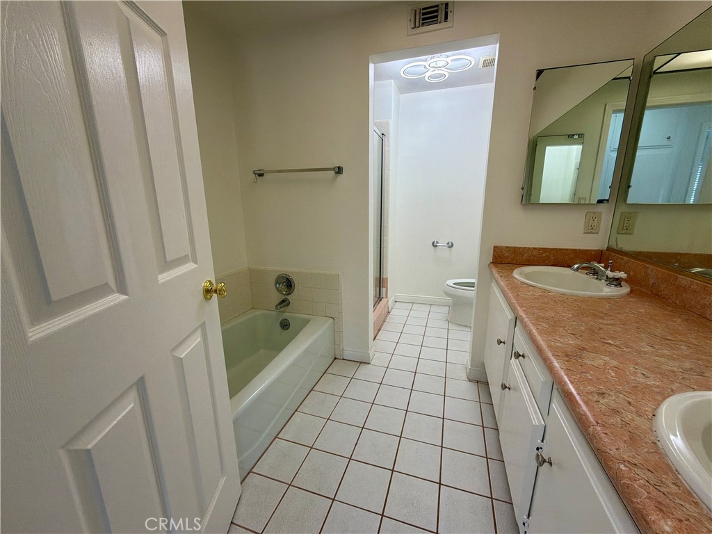 11932 Sonoma Way Porter Ranch, CA 91326 - Photo 44 of 63 a spacious bathroom with a tub a sink and a mirror