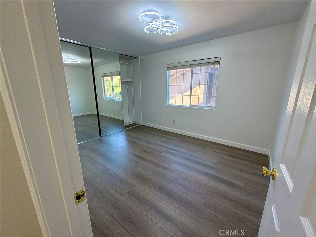 11932 Sonoma Way Porter Ranch, CA 91326 - Photo 46 of 63 a view of an empty room with wooden floor and a window