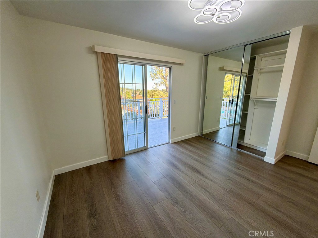11932 Sonoma Way Porter Ranch, CA 91326 - Photo 47 of 63 an empty room with wooden floor and windows