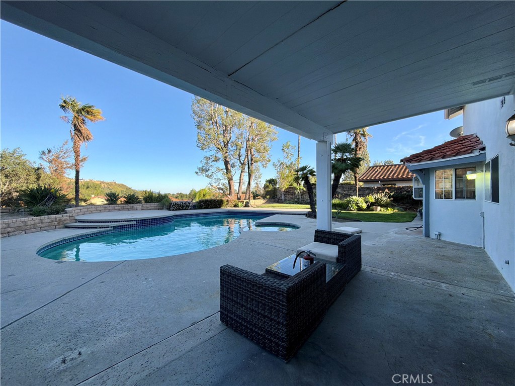 11932 Sonoma Way Porter Ranch, CA 91326 - Photo 55 of 63 a view of a patio with couches chairs and a potted plant