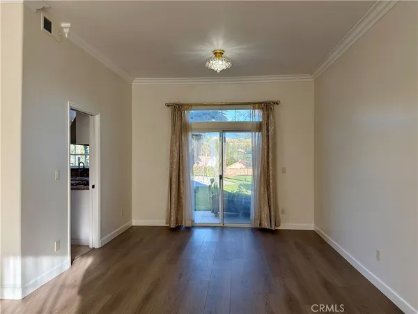 a view of empty room with wooden floor and fireplace