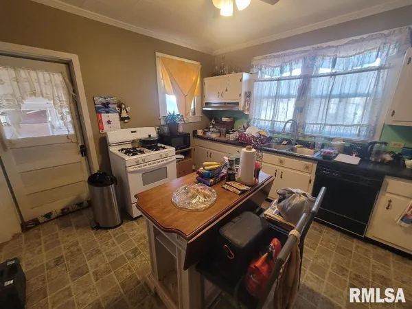 a kitchen with a stove a sink and a refrigerator
