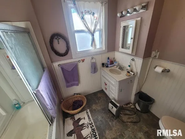 a bathroom with a sink mirror and toilet