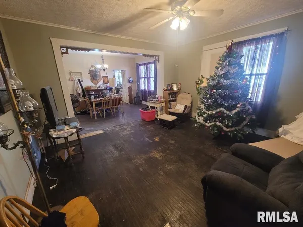 a living room with furniture and a chandelier
