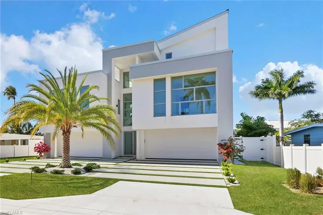 a front view of a house with swimming pool and porch