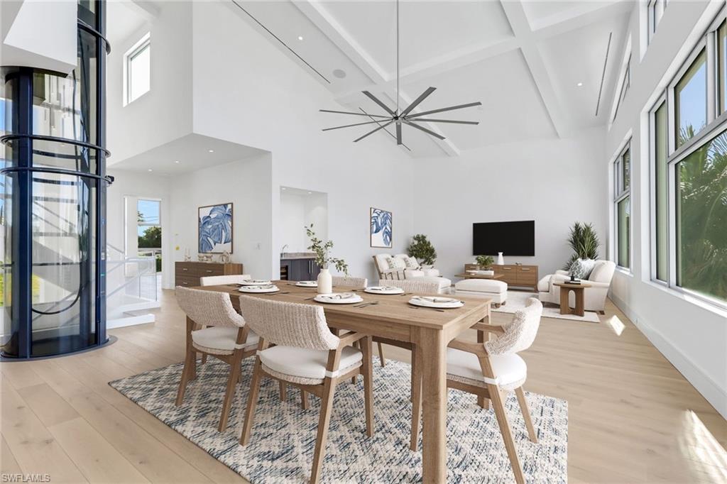 1798 Holiday Lane Naples, FL 34104 - Photo 11 of 31 a view of a dining room with furniture window and wooden floor