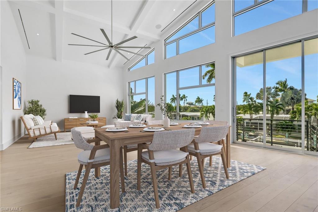 1798 Holiday Lane Naples, FL 34104 - Photo 13 of 31 a view of a dining room with furniture window and wooden floor