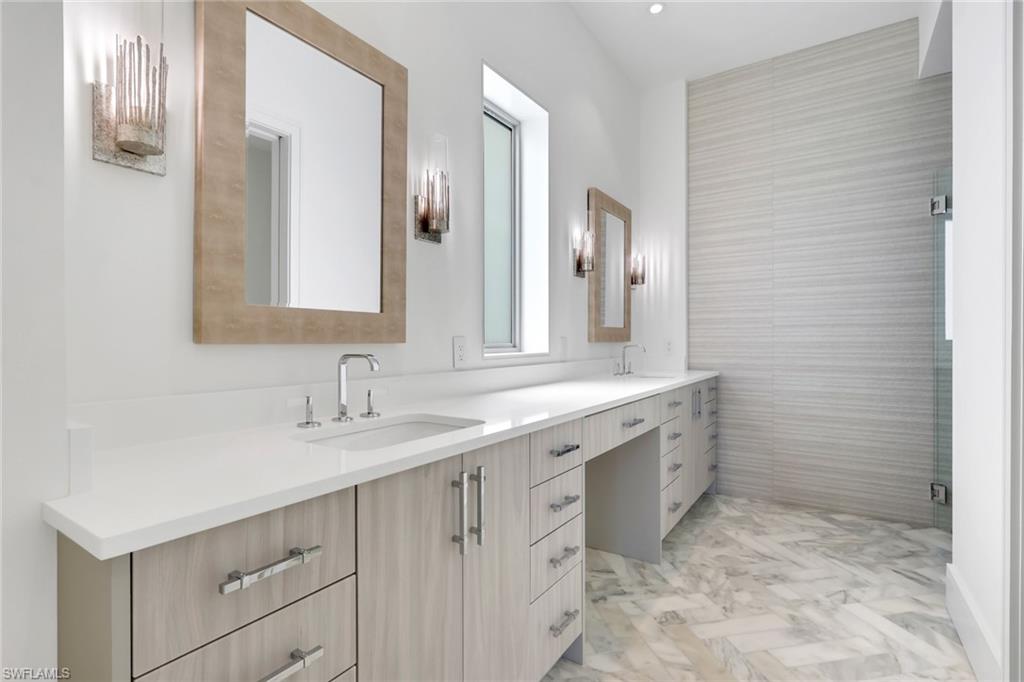 1798 Holiday Lane Naples, FL 34104 - Photo 16 of 31 a bathroom with a sink and a mirror