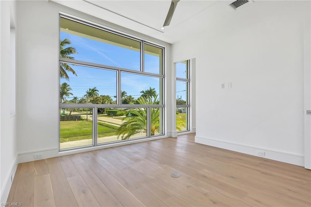 1798 Holiday Lane Naples, FL 34104 - Photo 17 of 31 a view of a porch with wooden floor and fence