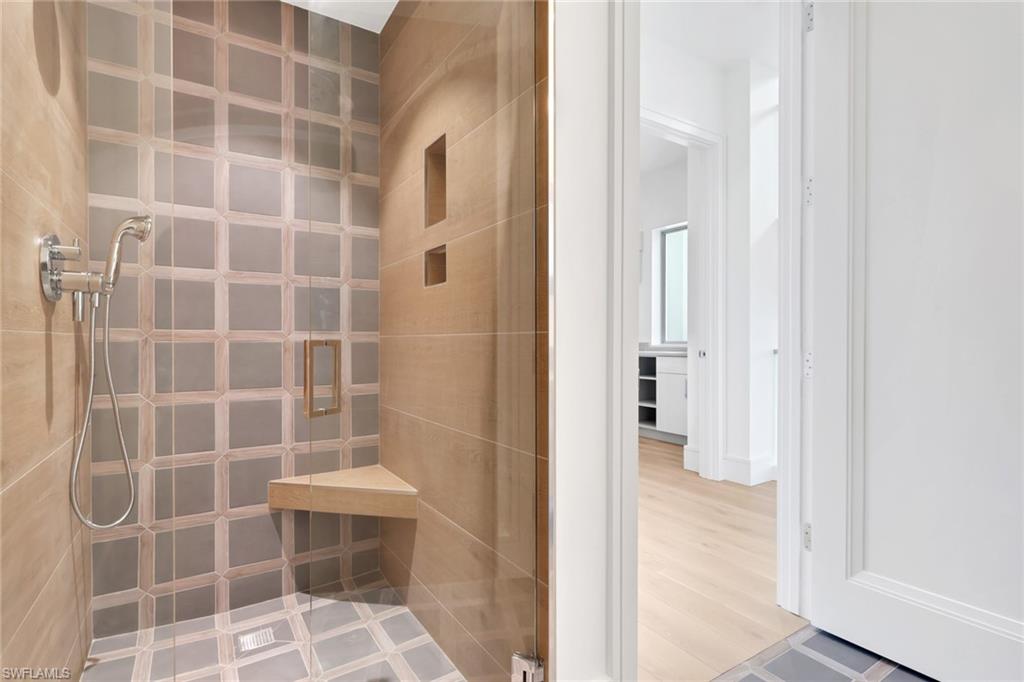 1798 Holiday Lane Naples, FL 34104 - Photo 19 of 31 a bathroom with a glass door shower