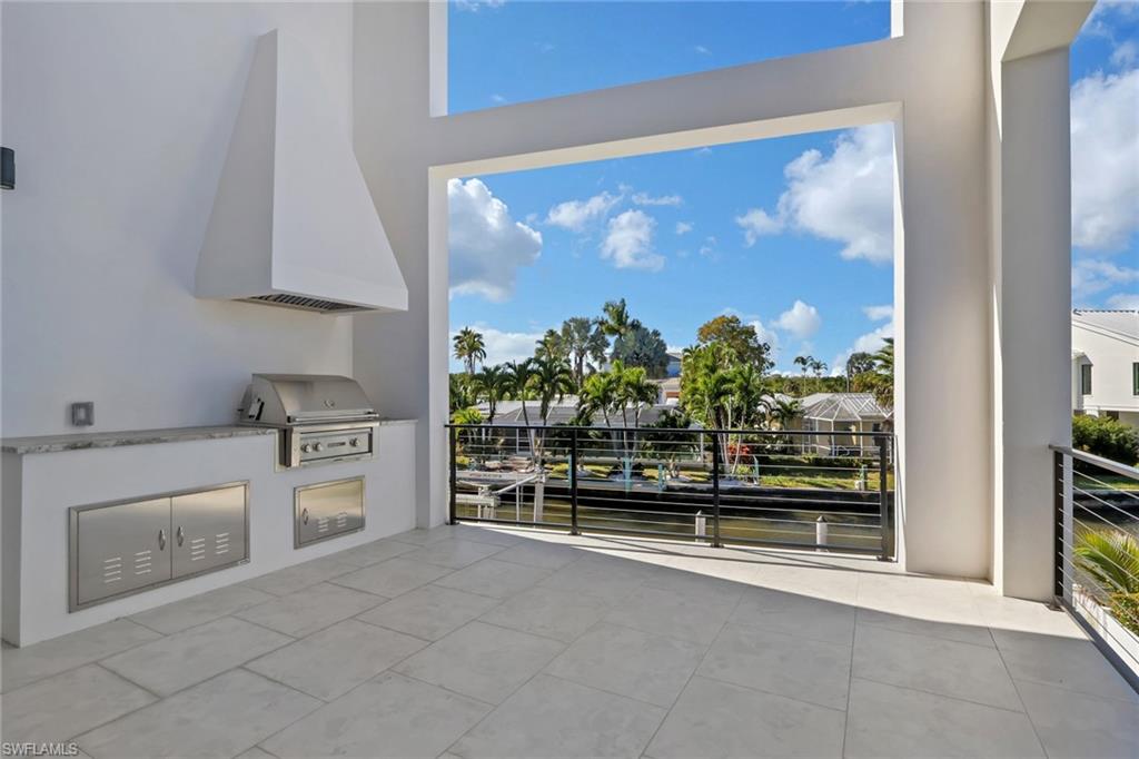 1798 Holiday Lane Naples, FL 34104 - Photo 20 of 31 a open kitchen with white cabinets and a stove