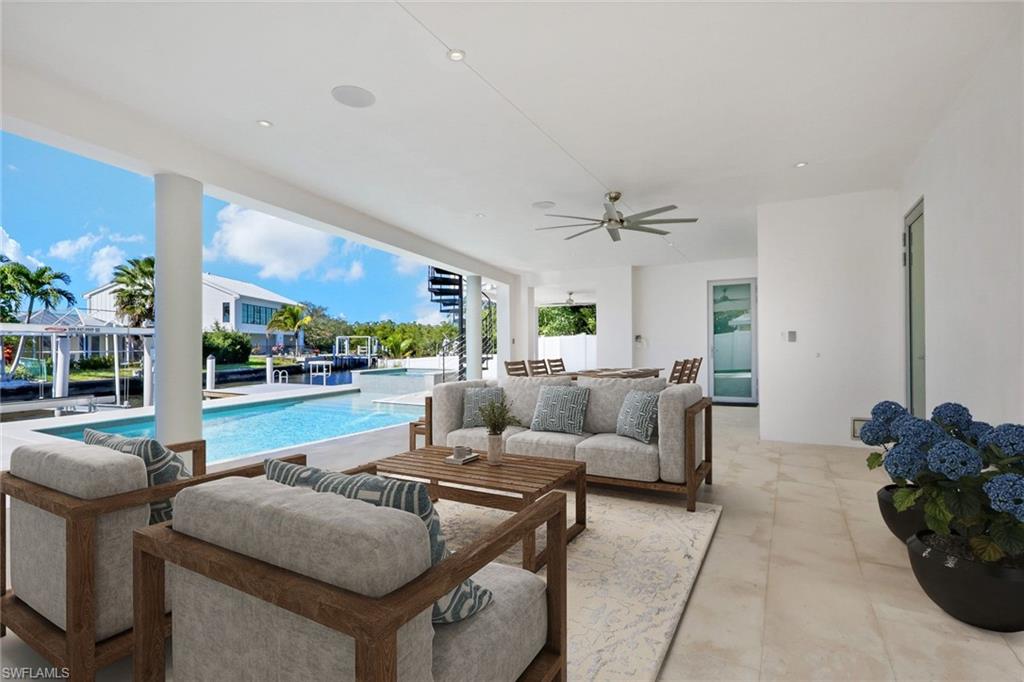 1798 Holiday Lane Naples, FL 34104 - Photo 22 of 31 a living room with furniture and a floor to ceiling window