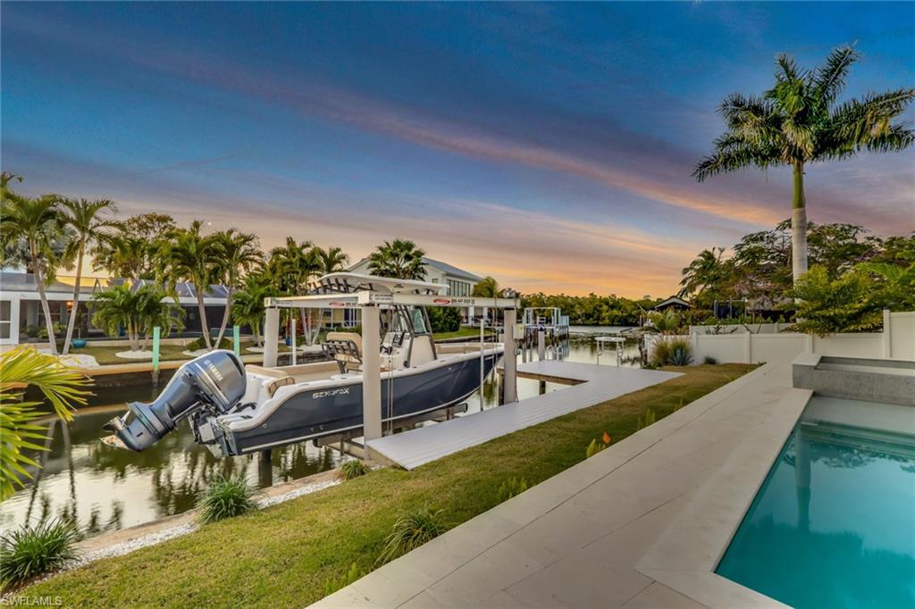 1798 Holiday Lane Naples, FL 34104 - Photo 26 of 31 a view of a swimming pool and lounge chairs