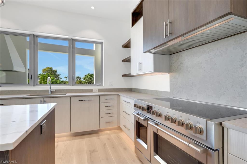 1798 Holiday Lane Naples, FL 34104 - Photo 6 of 31 a kitchen with a stove a sink and a refrigerator