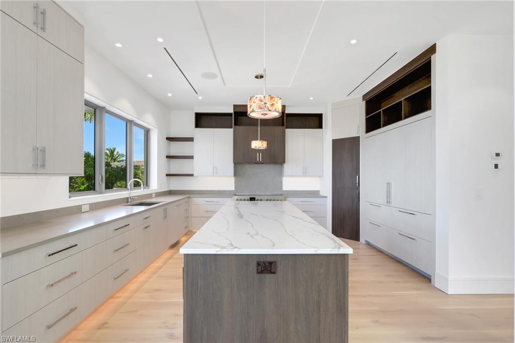 1798 Holiday Lane Naples, FL 34104 - Photo 7 of 31 a kitchen with stainless steel appliances granite countertop a sink and a stove