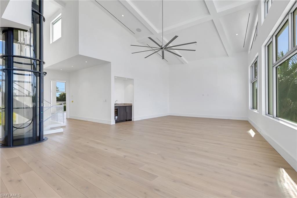 1798 Holiday Lane Naples, FL 34104 - Photo 10 of 31 a view of an empty room with a window and wooden floor