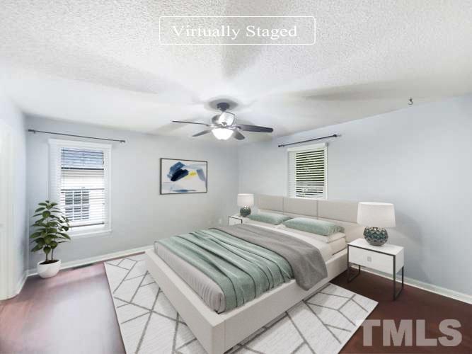 2025 Canterbury Road Clayton, NC 27520 - Photo 3 of 18 a bedroom with a large bed and a chandelier