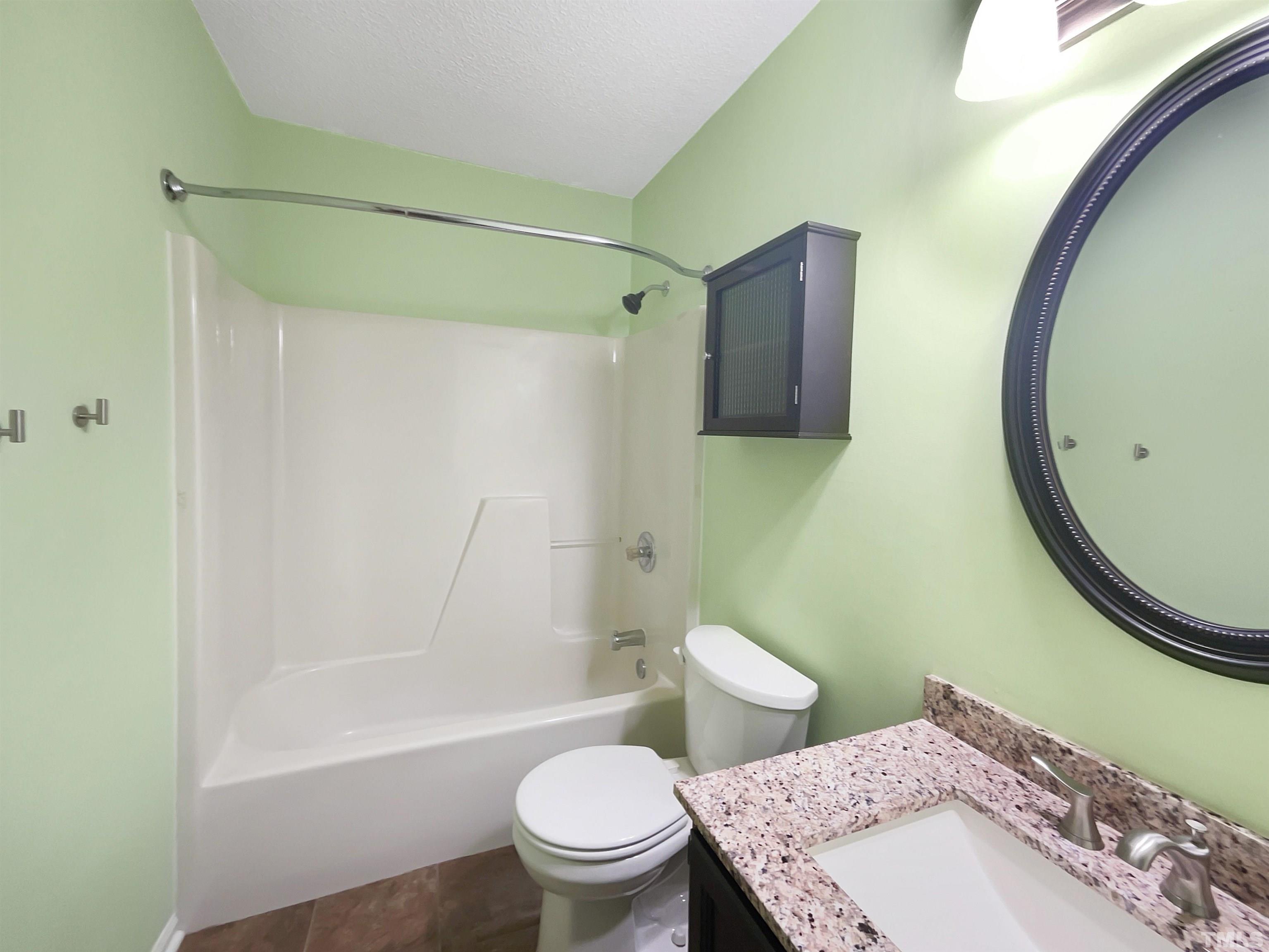 2025 Canterbury Road Clayton, NC 27520 - Photo 10 of 18 a bathroom with a sink toilet and shower