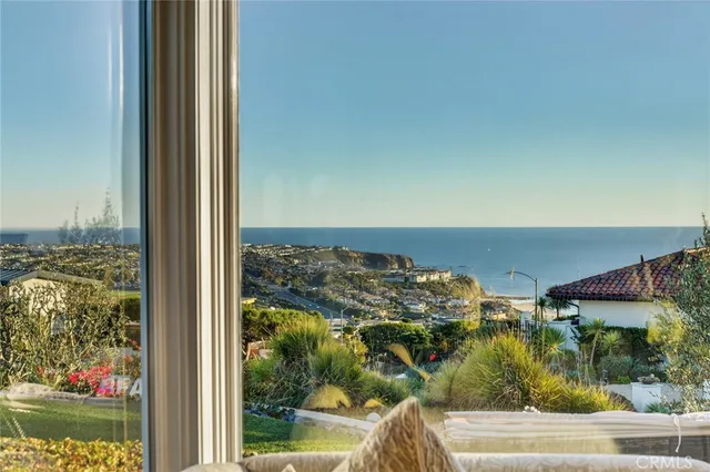 a living room with furniture a chandelier and a dining table