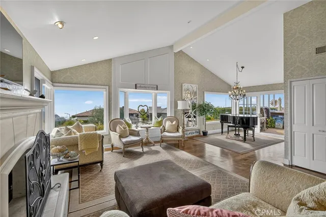 a living room with furniture and a floor to ceiling window