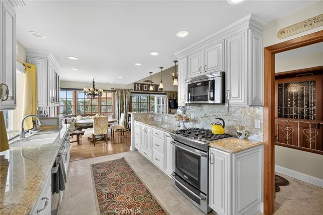 a kitchen with stainless steel appliances wooden floor a stove and a refrigerator