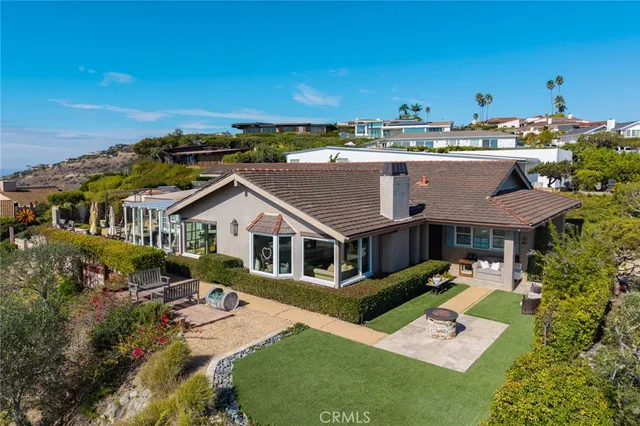 a view of a swimming pool with lawn chairs and a big yard