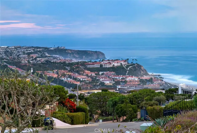 a living room with furniture large windows and view of living room