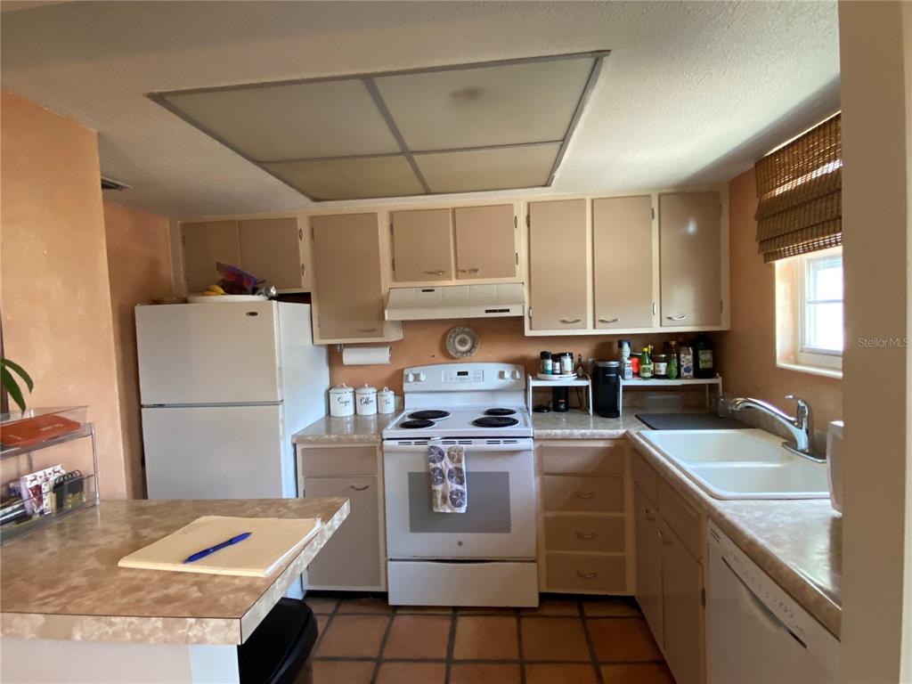1500 Gay Road, Unit 4D Winter Park, FL 32789 - Photo 4 of 15 a kitchen with stainless steel appliances granite countertop a stove a sink dishwasher and a refrigerator