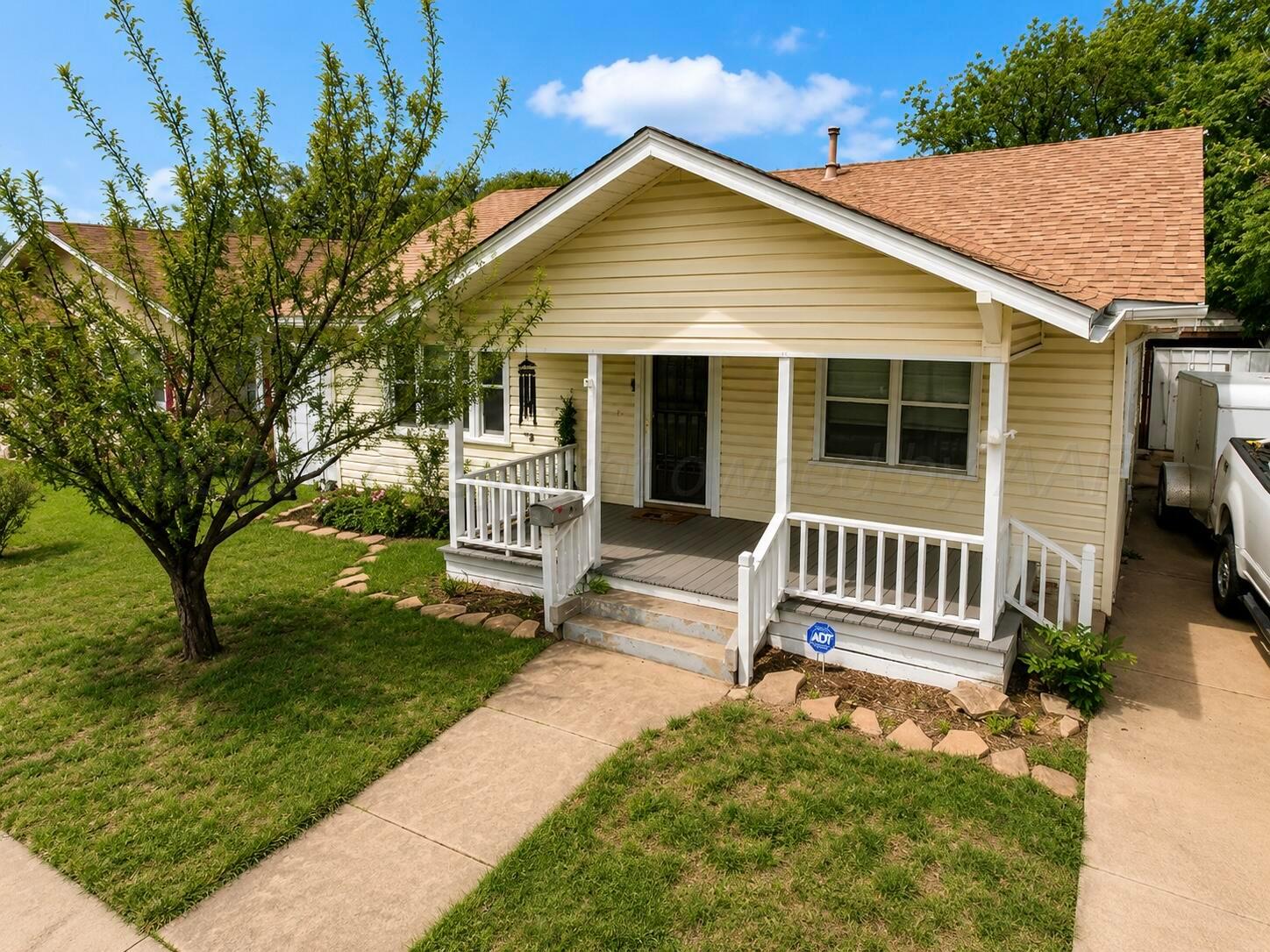 606 South Prospect Street Amarillo, TX 79106 - Photo 5 of 22 a porch with a bench next to a yard