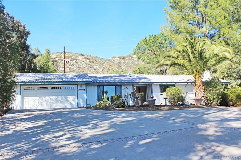 24118 Rutherford Road Ramona, CA 92065 - Photo 1 of 1 a front view of a house with a garden