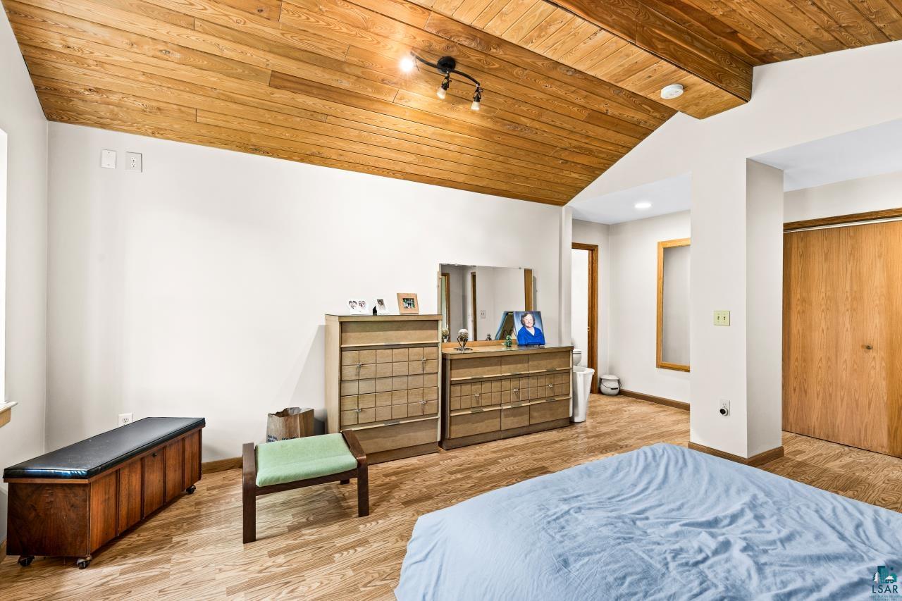 4800 Tower Road Moose Lake, MN 55767 - Photo 61 of 83 Vaulted wood-finish ceiling accentuates this room featuring wood-finish flooring, white painted walls, and a wood-finish bi-fold closet