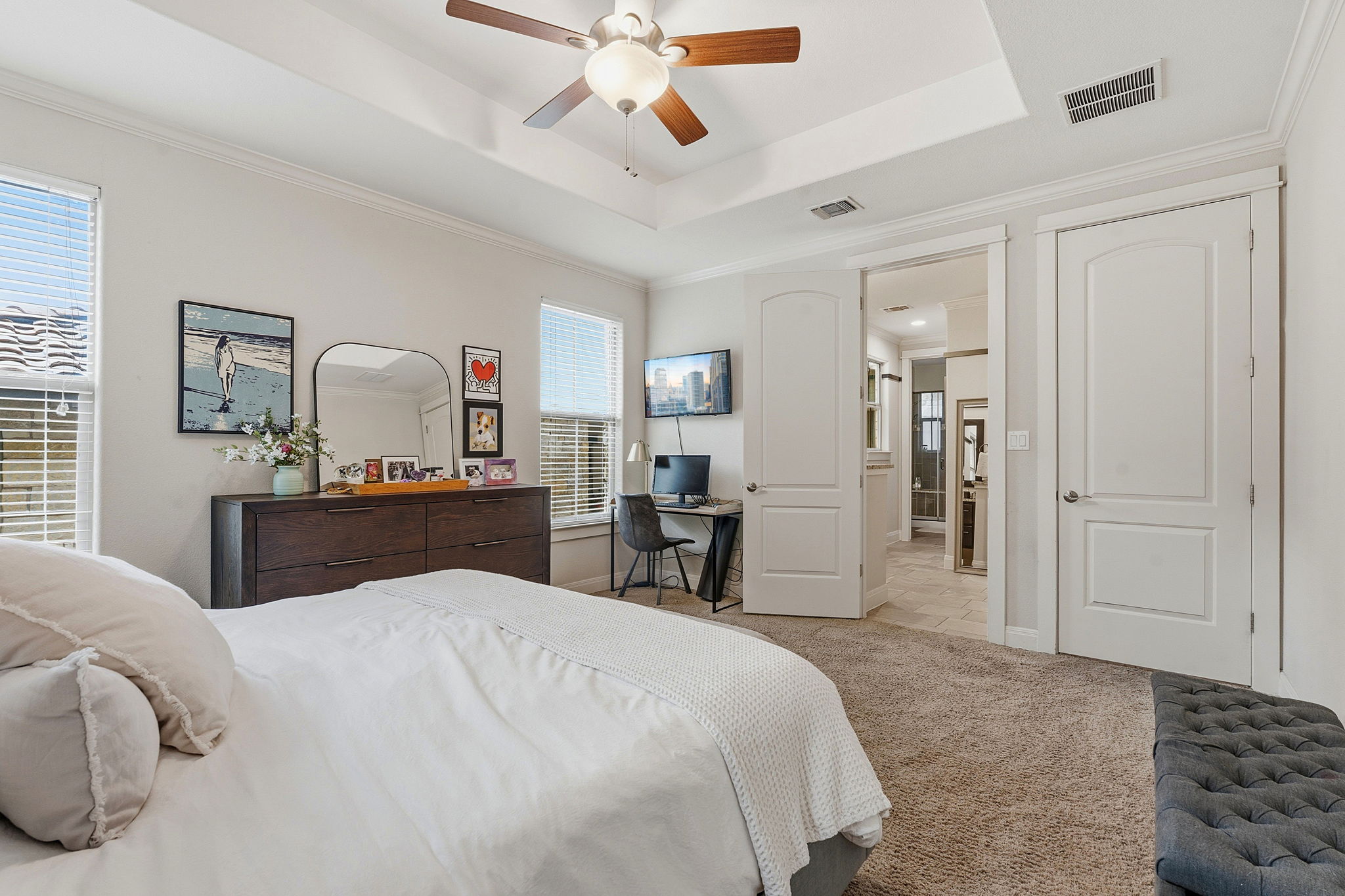 15317 Falconhead Grove Loop Austin, TX 78738 - Photo 15 of 36 Tray ceiling with a ceiling fan, two windows with blinds, and carpet flooring