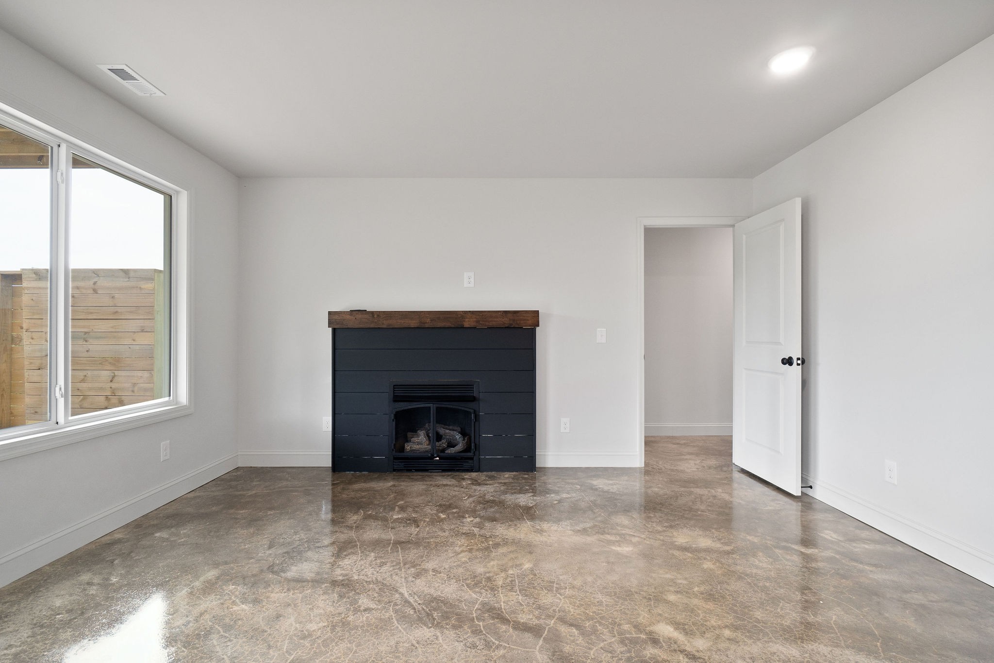 1124 Dale Ridge Road Dowelltown, TN 37059 - Photo 6 of 69 an empty room with a fireplace and windows