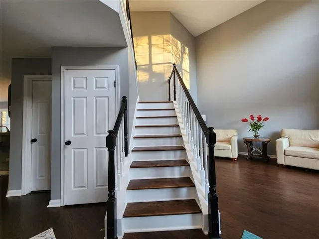 a view of entryway with wooden floor and stairs