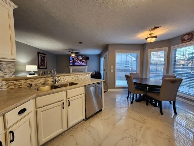 a kitchen with granite countertop cabinets table and chairs