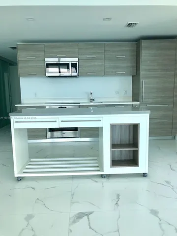 a stove top oven sitting inside of a kitchen