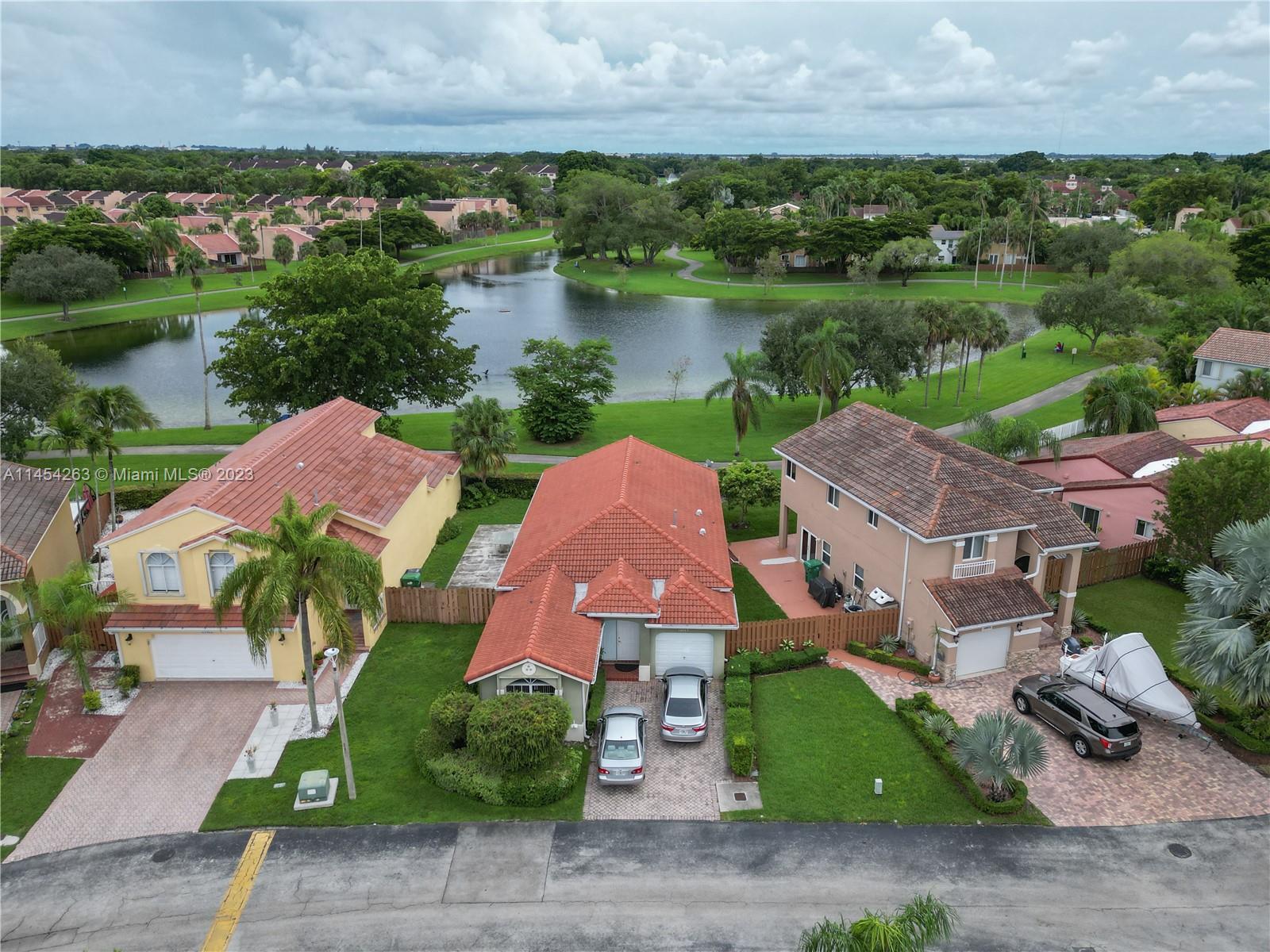 an aerial view of house with yard and lake view