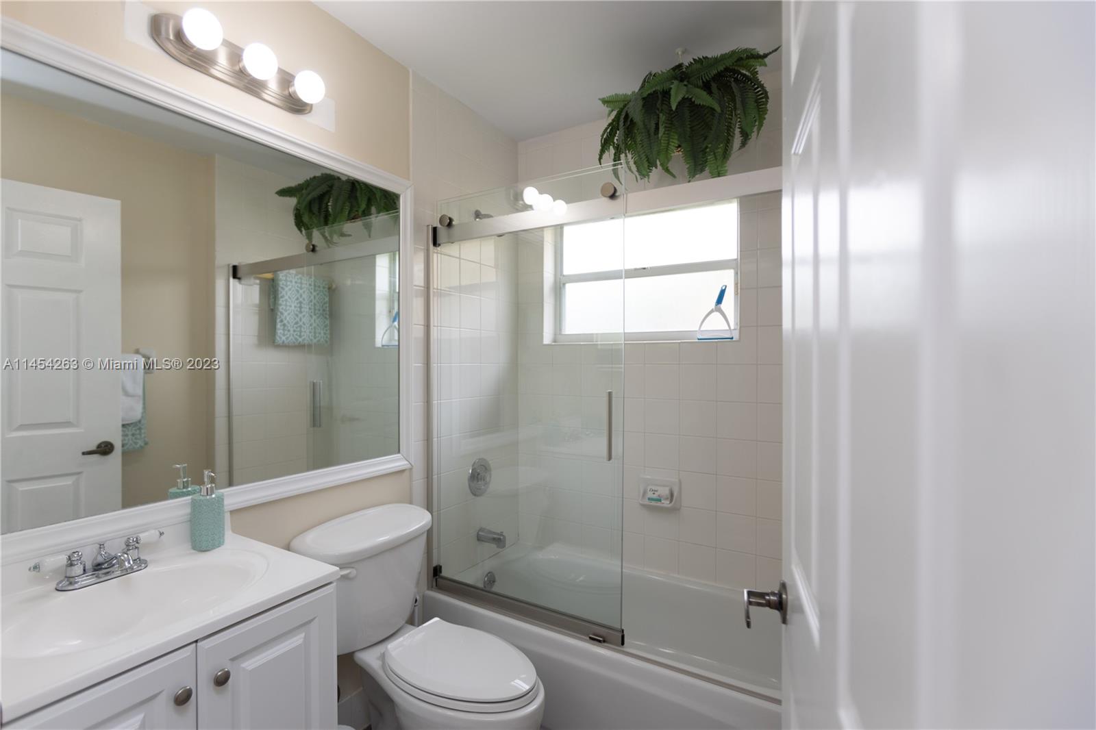 10067 Southwest 156th Avenue Miami, FL 33196 - Photo 11 of 21 a bathroom with a sink a toilet and shower