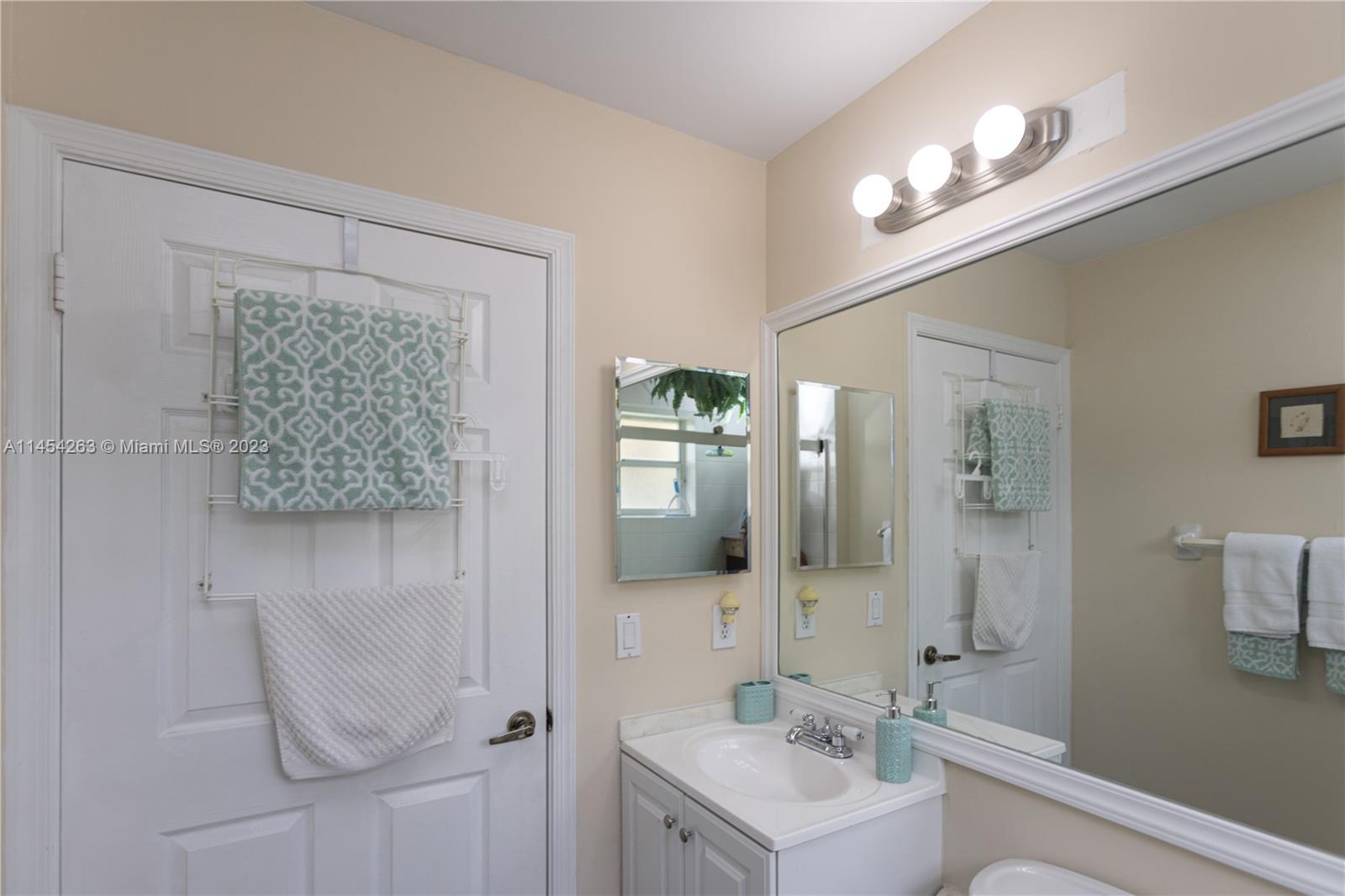 10067 Southwest 156th Avenue Miami, FL 33196 - Photo 12 of 21 a bathroom with a sink a light fixture and a mirror