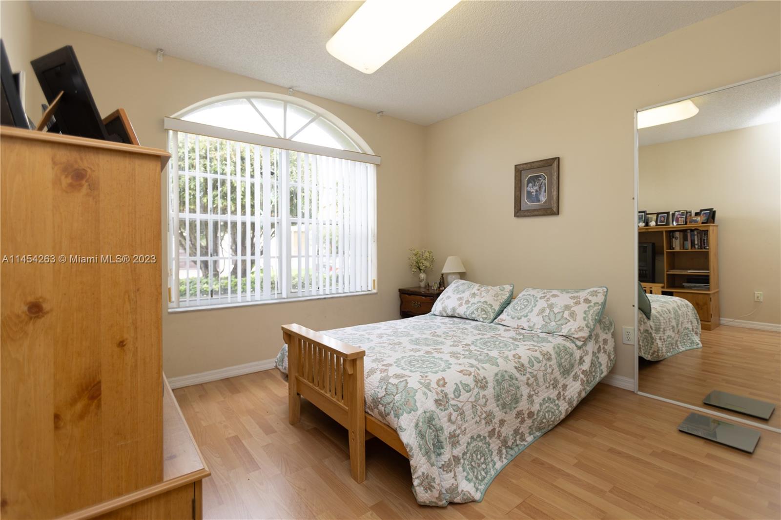 10067 Southwest 156th Avenue Miami, FL 33196 - Photo 13 of 21 a bedroom with a bed and a window