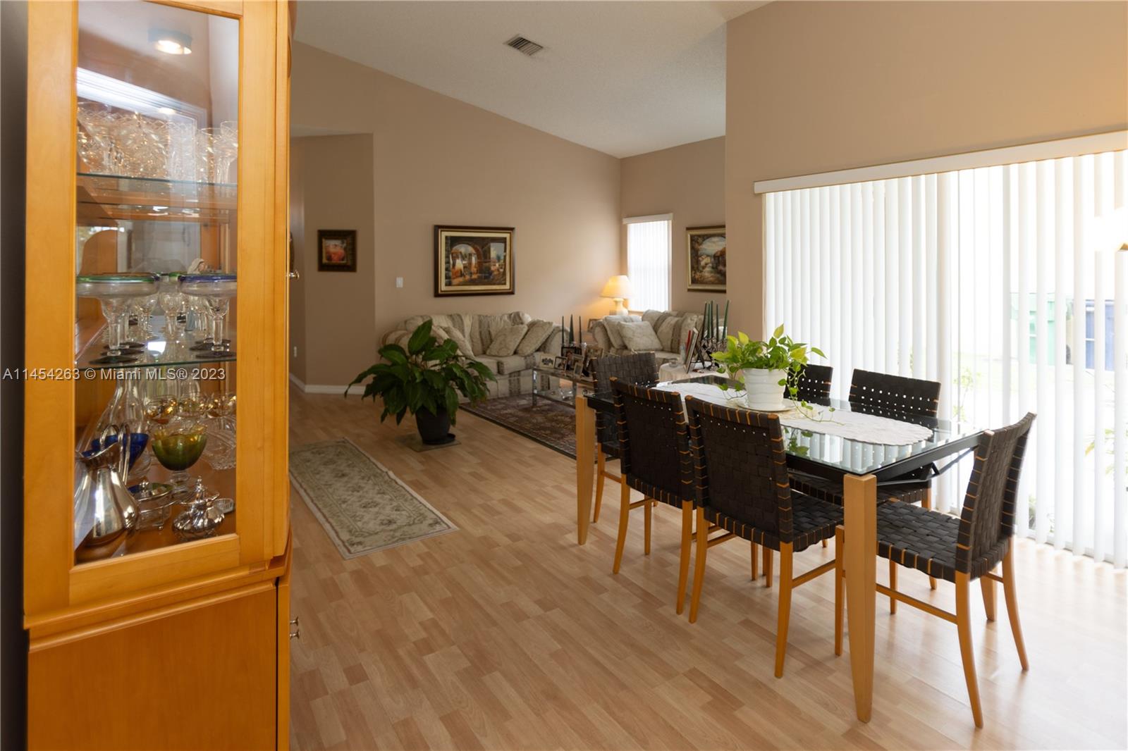 10067 Southwest 156th Avenue Miami, FL 33196 - Photo 15 of 21 a dining room with furniture and wooden floor