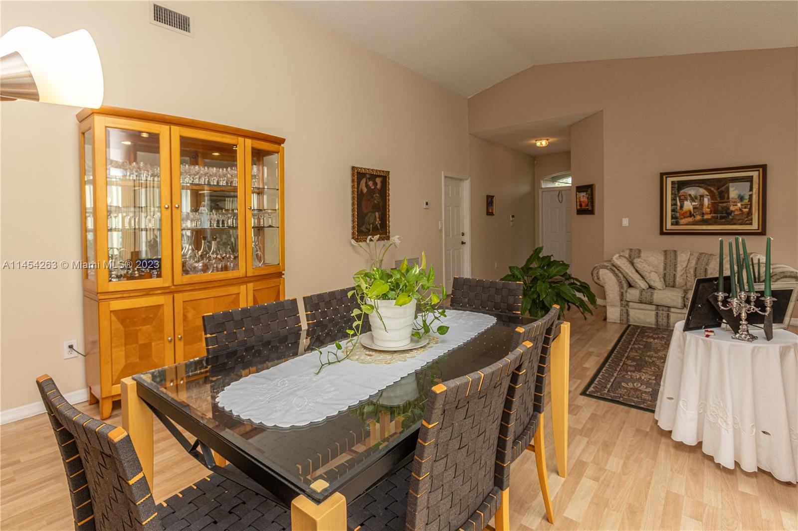 10067 Southwest 156th Avenue Miami, FL 33196 - Photo 17 of 21 a dining room with furniture and wooden floor