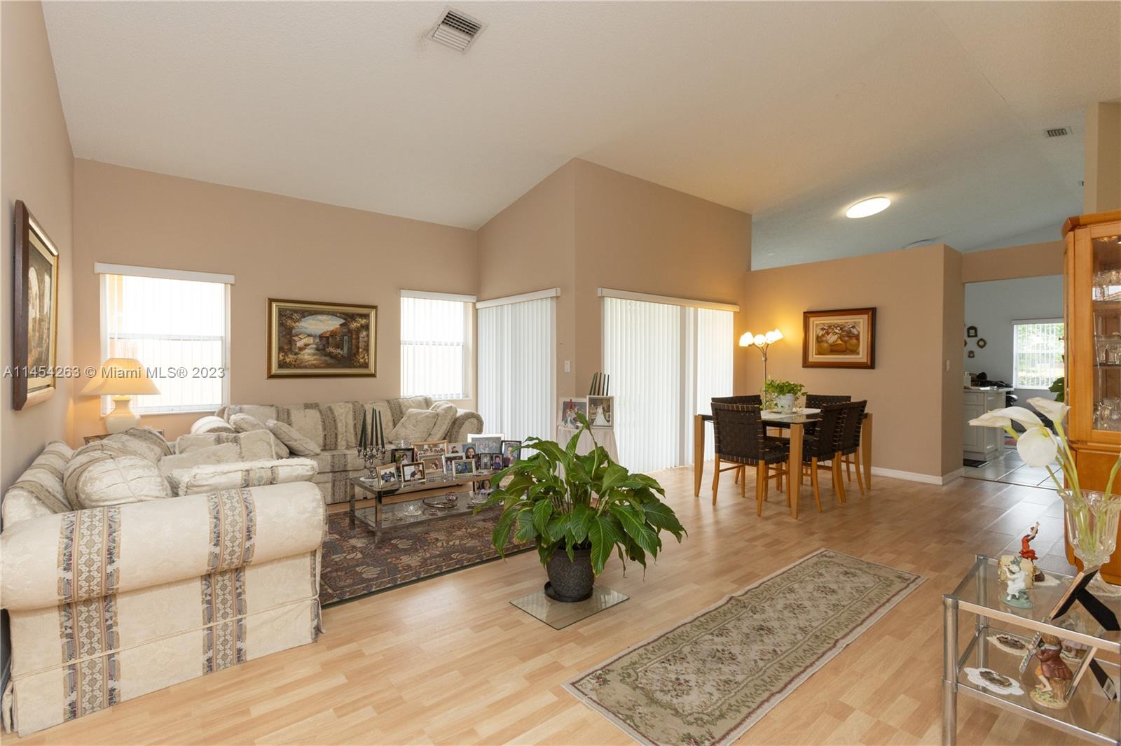 10067 Southwest 156th Avenue Miami, FL 33196 - Photo 19 of 21 a living room with furniture large window and wooden floor